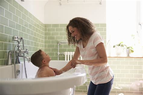 Stepson helping her stepmom to taking bath 